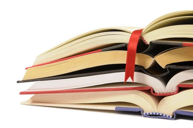 Small pile of open books with red bookmark ribbon isolated on wh
